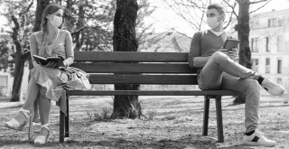 couple-sitting-apart-on-a-bench